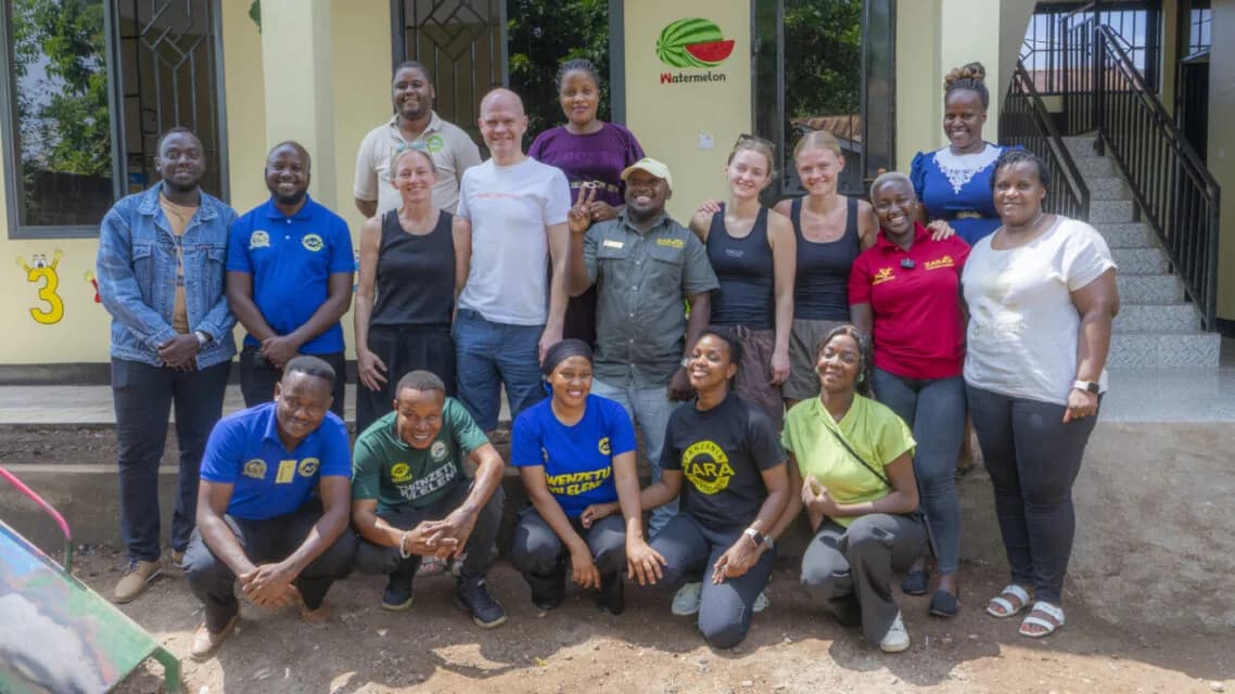 The ZARA Charity staff and volunteer team photographed together on the steps outside the Moshi office.